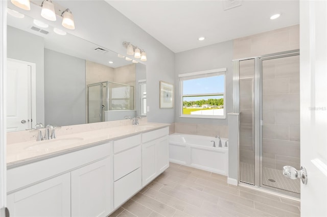 1875 NW 44 Court Rd, Ocala, FL 34482 - bathroom featuring a stall shower, a garden tub, double vanity, and recessed lighting