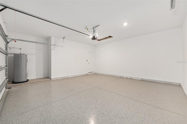 1875 NW 44 Court Rd, Ocala, FL 34482 - garage with electric water heater, a garage door opener, baseboards, and recessed lighting