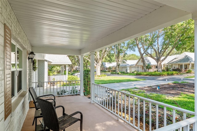 view of patio / terrace featuring a porch and a residential view