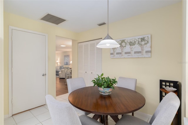 dining space featuring light tile patterned floors and baseboards