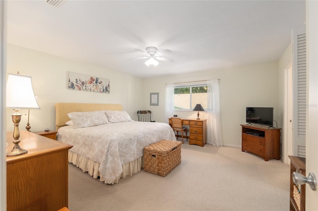 bedroom with light carpet and ceiling fan
