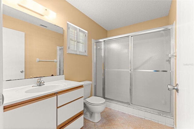 full bathroom with toilet, a shower stall, vanity, and a textured ceiling