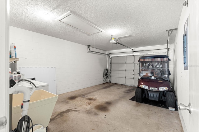 garage featuring a garage door opener and concrete block wall
