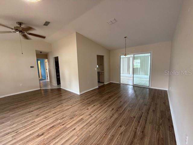17522 SE 96th Ct, Summerfield, FL 34491 - spare room with vaulted ceiling, wood finished floors, and ceiling fan