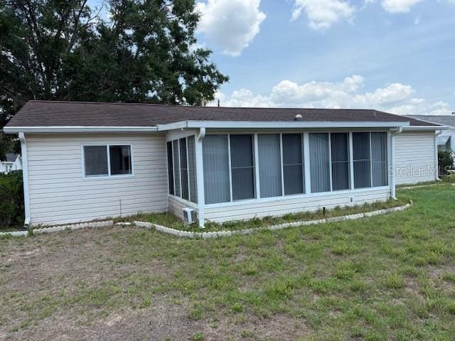 17522 SE 96th Ct, Summerfield, FL 34491 - back of house with a sunroom and a yard
