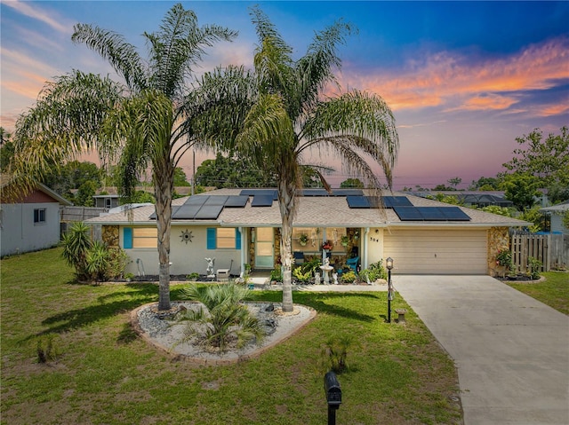 304 S Tyler St, Beverly Hills, FL 34465 - mid-century home with concrete driveway, roof mounted solar panels, a garage, and stucco siding