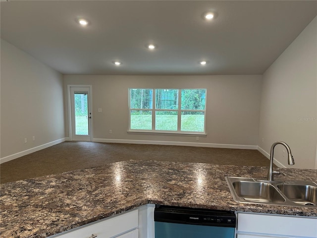 kitchen featuring a sink, dishwasher, white cabinets, baseboards, and recessed lighting