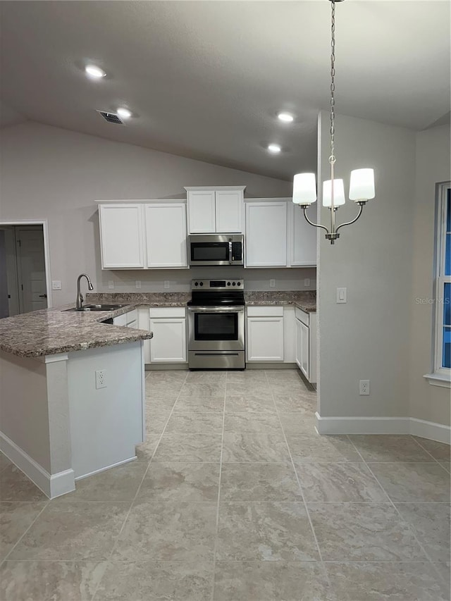 kitchen featuring stainless steel appliances, lofted ceiling, stone counters, a peninsula, and white cabinetry