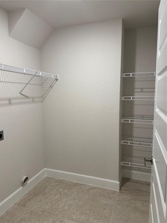 laundry room featuring electric dryer hookup and baseboards