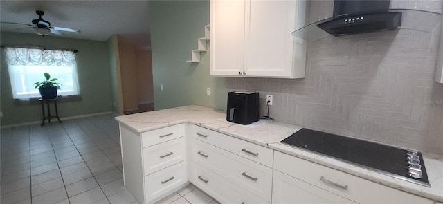 3891 N Grapefern Way, Beverly Hills, FL 34465 - kitchen with light tile patterned flooring, black electric cooktop, ceiling fan, white cabinetry, and light stone countertops