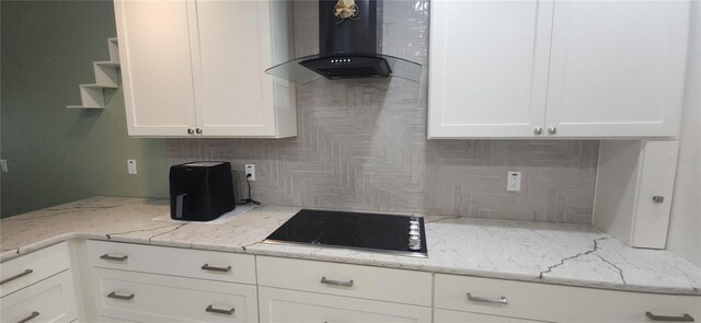 3891 N Grapefern Way, Beverly Hills, FL 34465 - kitchen with black electric stovetop, wall chimney range hood, decorative backsplash, and white cabinetry