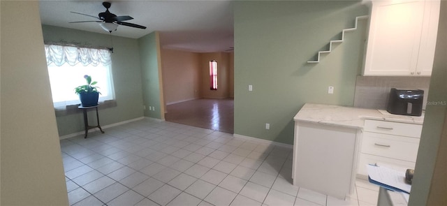 3891 N Grapefern Way, Beverly Hills, FL 34465 - kitchen with white cabinets, light tile patterned floors, ceiling fan, light stone countertops, and baseboards