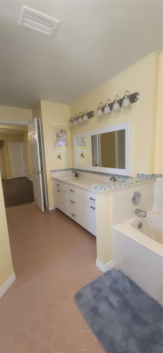 3891 N Grapefern Way, Beverly Hills, FL 34465 - bathroom featuring a garden tub, baseboards, and vanity