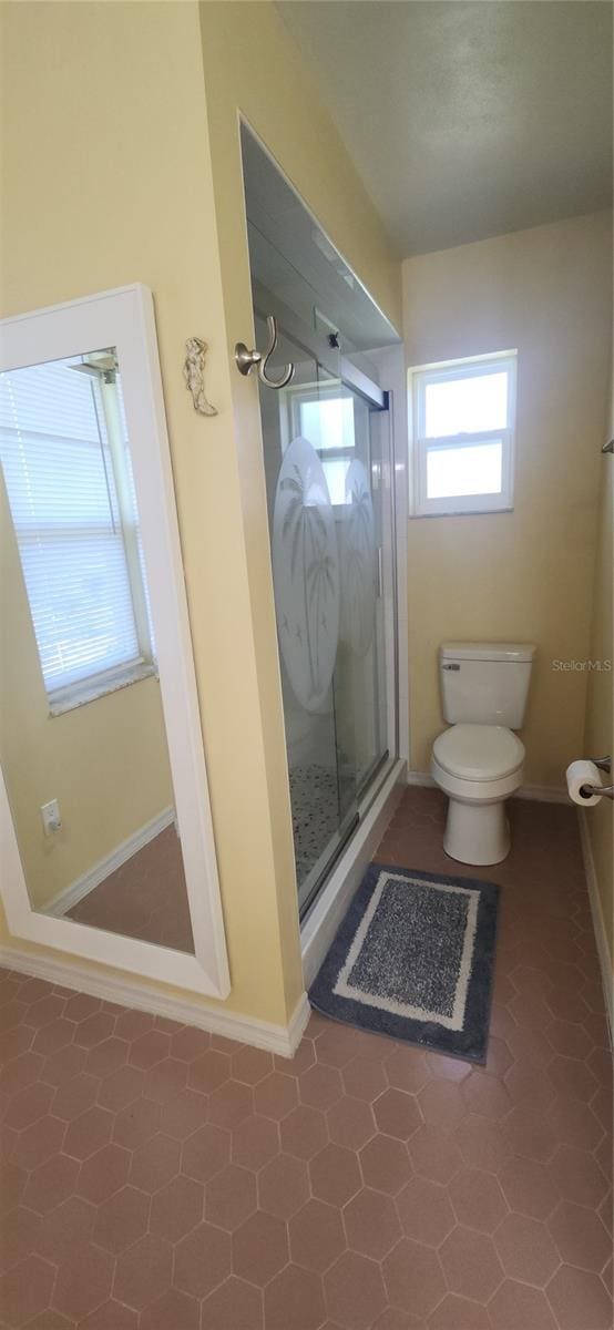 3891 N Grapefern Way, Beverly Hills, FL 34465 - bathroom featuring a shower stall, toilet, and baseboards