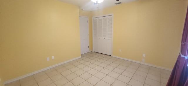 3891 N Grapefern Way, Beverly Hills, FL 34465 - unfurnished bedroom with a closet, baseboards, ceiling fan, and light tile patterned floors