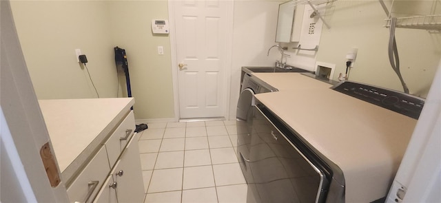 3891 N Grapefern Way, Beverly Hills, FL 34465 - washroom with washing machine and clothes dryer, cabinet space, light tile patterned flooring, and baseboards