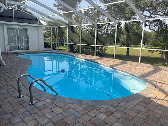 swimming pool with a lanai and a patio area