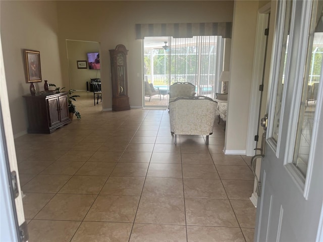 foyer featuring baseboards and light tile patterned floors