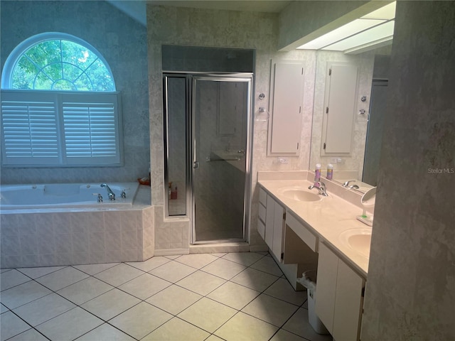 bathroom with tile patterned floors, a bath, a stall shower, and double vanity