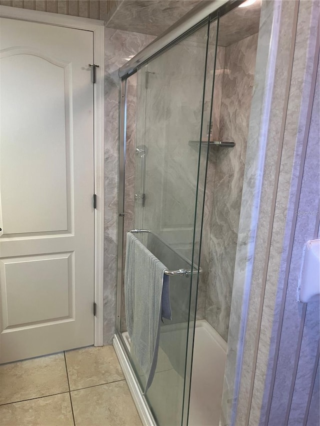 bathroom featuring a stall shower and tile patterned flooring