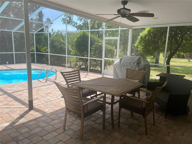 sunroom / solarium with a ceiling fan and outdoor dining area