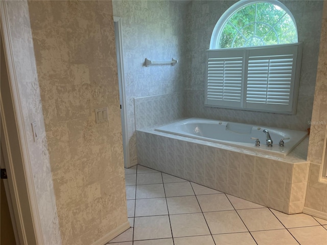 bathroom with a garden tub and tile patterned floors