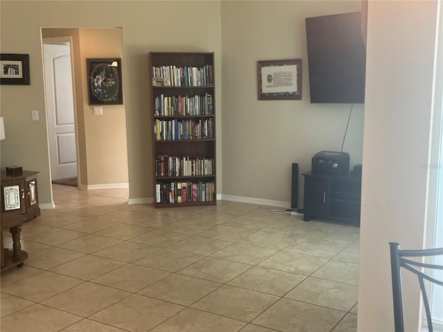 living room featuring light tile patterned flooring and baseboards