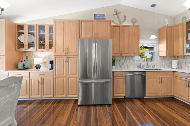 kitchen featuring stainless steel appliances, a sink, lofted ceiling, and light countertops