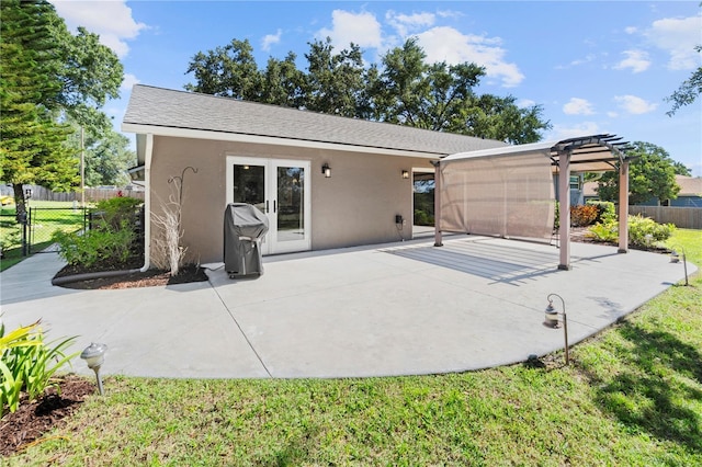rear view of property featuring stucco siding, a patio, a pergola, and a shingled roof