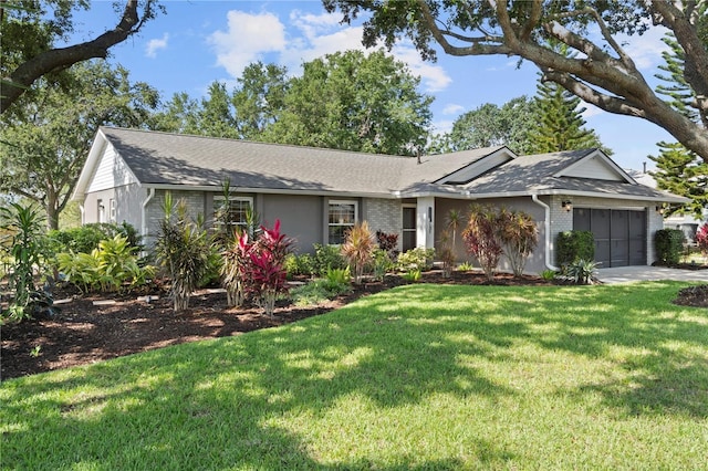 single story home with a garage, a front yard, brick siding, and concrete driveway
