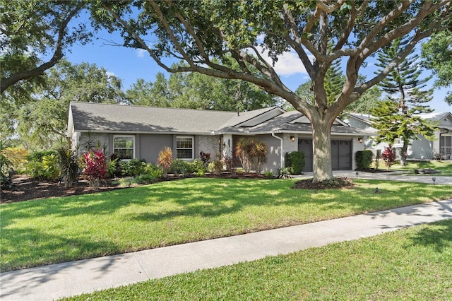 ranch-style home with a garage, concrete driveway, and a front lawn