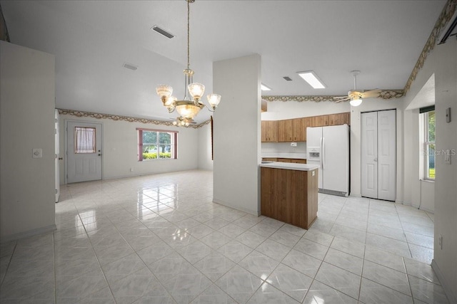 4992 NW 31st St, Ocala, FL 34482 - kitchen featuring white fridge with ice dispenser, brown cabinets, a chandelier, light countertops, and open floor plan