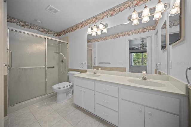 4992 NW 31st St, Ocala, FL 34482 - full bathroom with toilet, double vanity, a stall shower, and tile patterned flooring