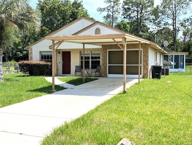 21298 SW Peach Blossom St, Dunnellon, FL 34431 - view of front of house featuring a garage, stone siding, concrete driveway, a front yard, and stucco siding