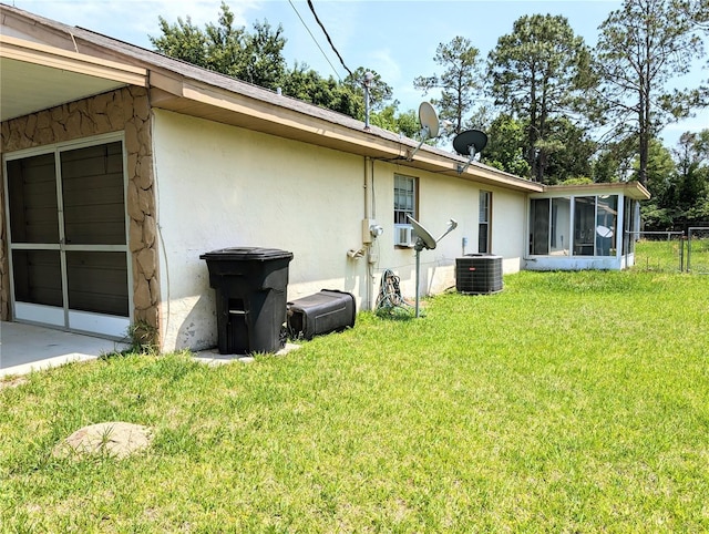 21298 SW Peach Blossom St, Dunnellon, FL 34431 - rear view of house with a sunroom, stucco siding, and cooling unit