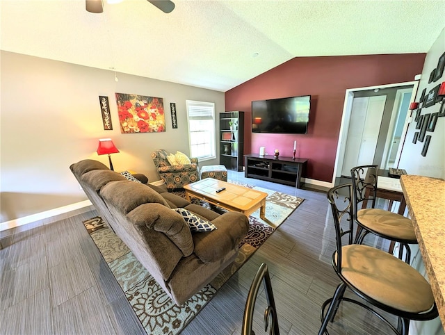 21298 SW Peach Blossom St, Dunnellon, FL 34431 - living room featuring baseboards, vaulted ceiling, a ceiling fan, a textured ceiling, and wood finished floors