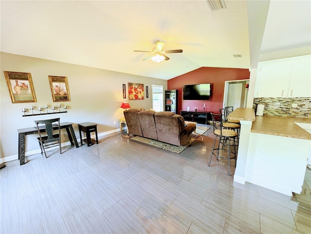 21298 SW Peach Blossom St, Dunnellon, FL 34431 - living area featuring ceiling fan, lofted ceiling, and baseboards