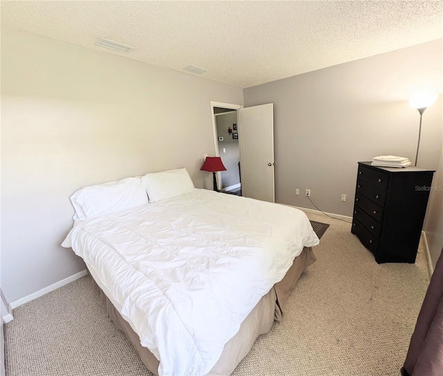 21298 SW Peach Blossom St, Dunnellon, FL 34431 - bedroom featuring light carpet, a textured ceiling, and baseboards