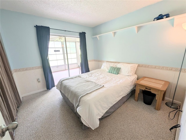 21298 SW Peach Blossom St, Dunnellon, FL 34431 - carpeted bedroom with a textured ceiling and wainscoting