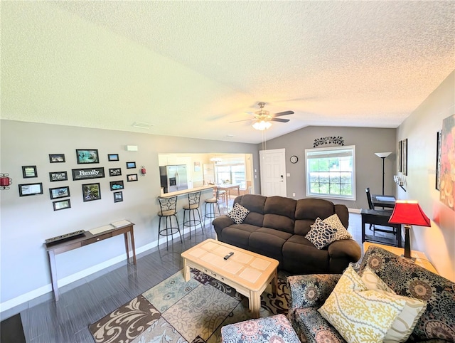 21298 SW Peach Blossom St, Dunnellon, FL 34431 - living area with vaulted ceiling, a ceiling fan, baseboards, wood finished floors, and a textured ceiling