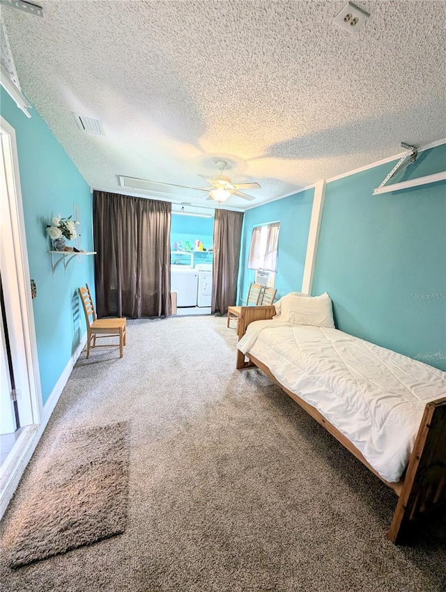 21298 SW Peach Blossom St, Dunnellon, FL 34431 - bedroom featuring a textured ceiling, washer and clothes dryer, attic access, carpet, and a ceiling fan