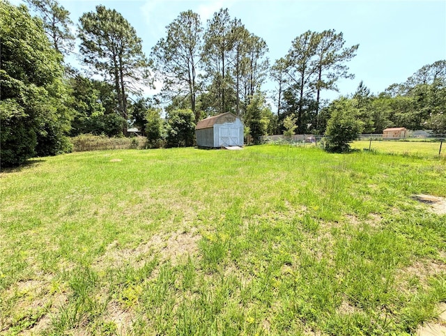 21298 SW Peach Blossom St, Dunnellon, FL 34431 - view of yard with a storage shed, fence, and an outbuilding