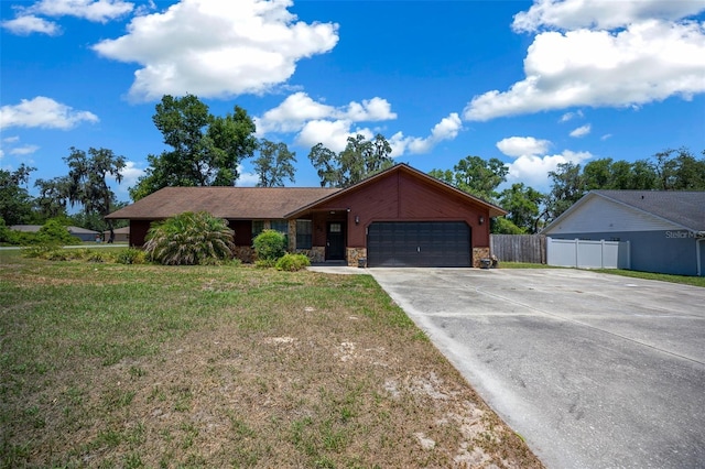 23 Larch Crse, Ocala, FL 34480 - ranch-style house with stone siding, an attached garage, and driveway