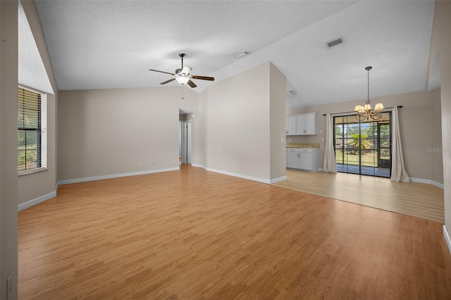 23 Larch Crse, Ocala, FL 34480 - unfurnished living room with lofted ceiling, a chandelier, a ceiling fan, light wood-style flooring, and baseboards