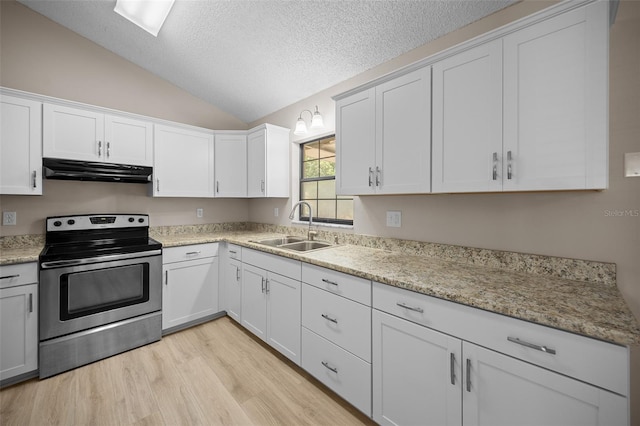 23 Larch Crse, Ocala, FL 34480 - kitchen featuring stainless steel range with electric stovetop, under cabinet range hood, a sink, vaulted ceiling, and light wood-style floors