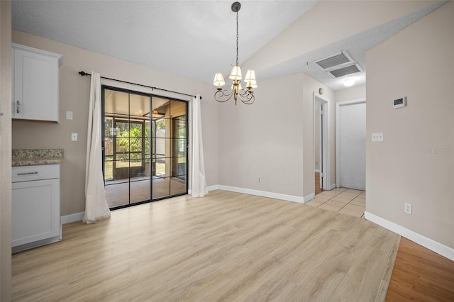 23 Larch Crse, Ocala, FL 34480 - unfurnished dining area with a chandelier, light wood-style floors, vaulted ceiling, and baseboards