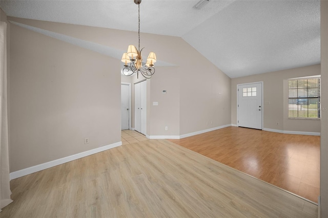 23 Larch Crse, Ocala, FL 34480 - interior space featuring lofted ceiling, a chandelier, light wood-type flooring, and baseboards