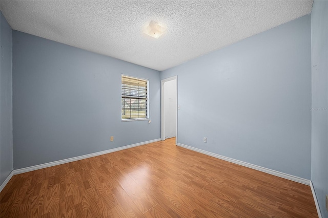 23 Larch Crse, Ocala, FL 34480 - spare room featuring light wood-style flooring, a textured ceiling, and baseboards