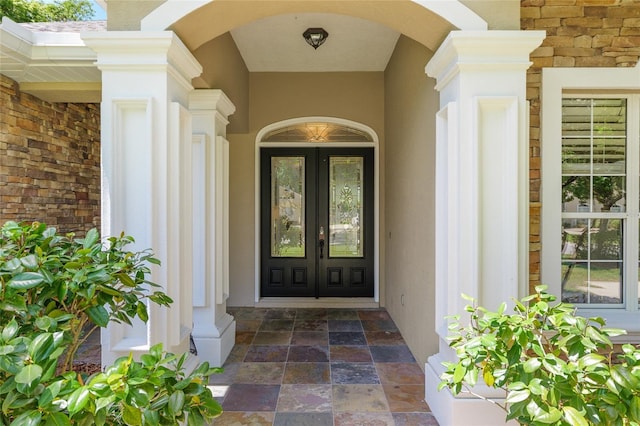 doorway to property with french doors and stucco siding