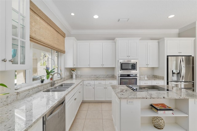 kitchen with stainless steel appliances, a sink, open shelves, white cabinetry, and ornamental molding